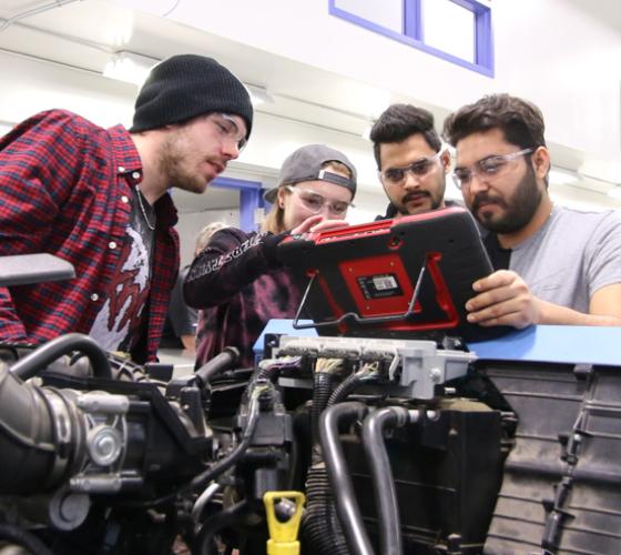 Motive Power students in the lab troubleshooting work for vehicle