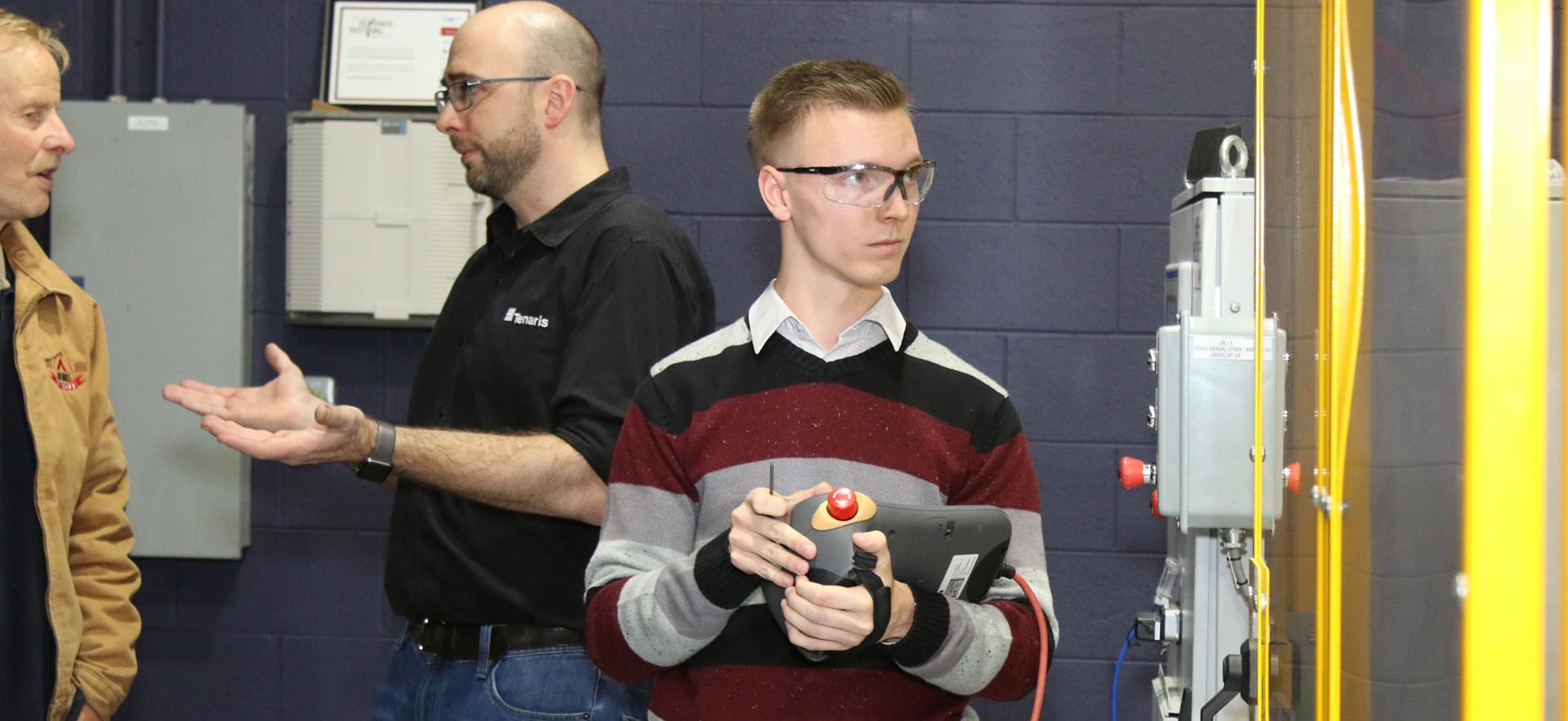 Engineering student controlling robotics arm