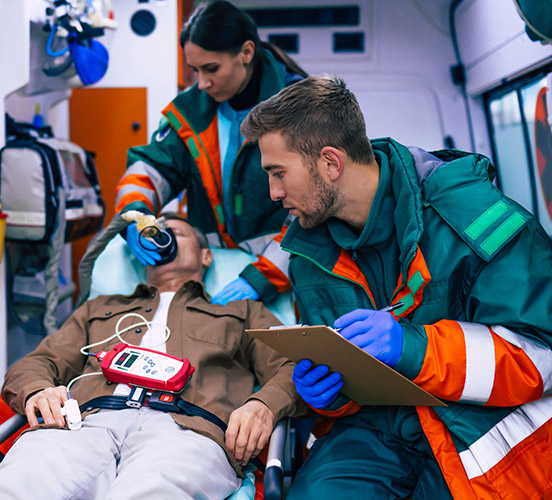 EMTs caring for a man inside an ambulance