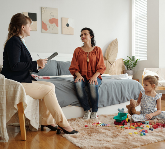 Social service worker in the home with mother and child
