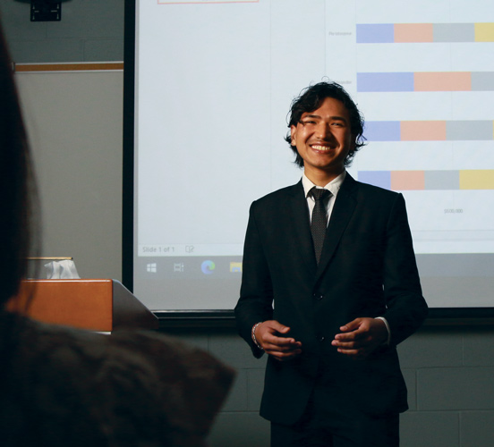 Business student smiling during a presentation in front of the class