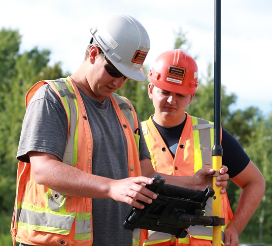 Construction Engineering student with employer on road construction site