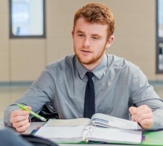 Sault College Business student reviews his homework notes.