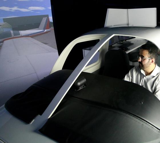 Aviation instructor operating one of the flight simulators.