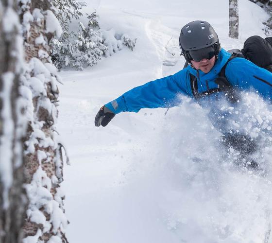 Snowboarder coming down the ski hill