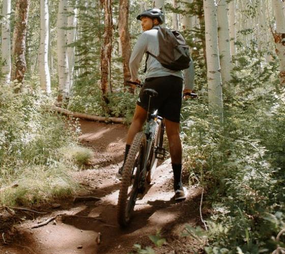 Young man on a mountain bike trail.