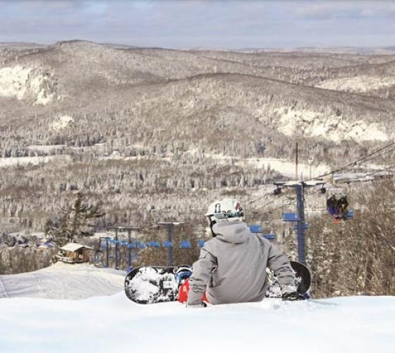 Snowboarder on top of the ski hill