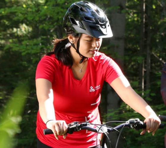 student with helmet on hub trail