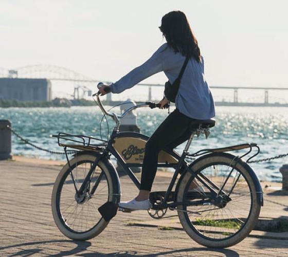 Girl on bike riding on Sault Ste. Marie boardwalk