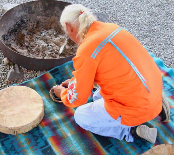 Elder in our sacred fire arbour preparing for ritual