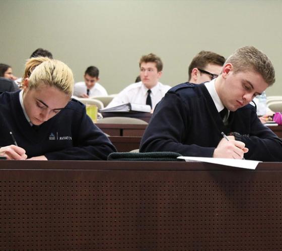 Students writing in class.