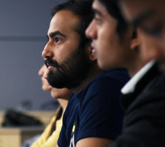 male student listening in class.