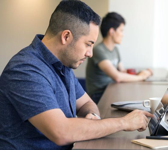 Male mature student doing research.