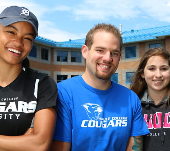 Students smiling outside campus residence