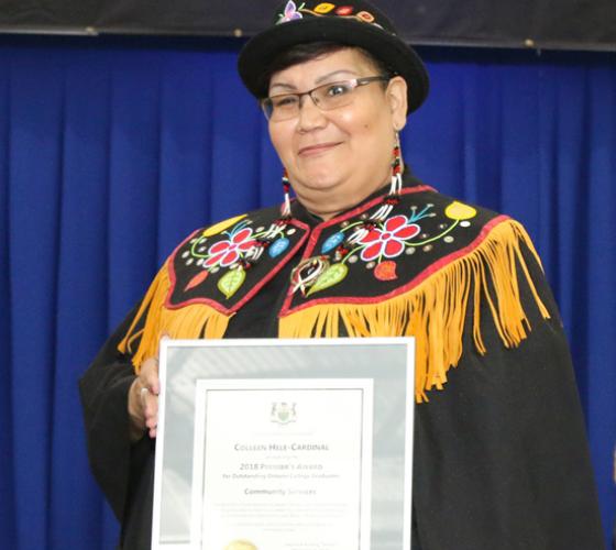 Female graduating student receiving an award.