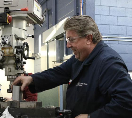 Instructor working at machine 
