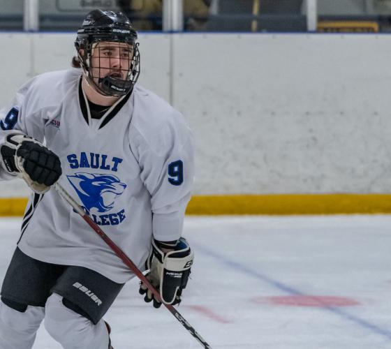 Hockey player skating across the ice