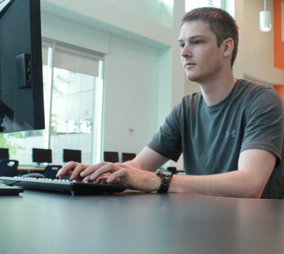 student at computer workstation