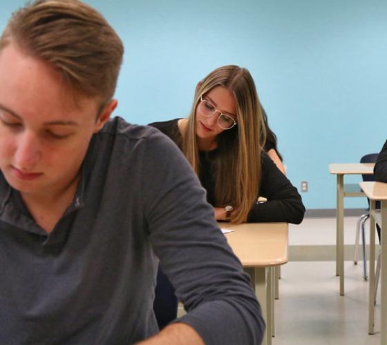 students writing in classroom