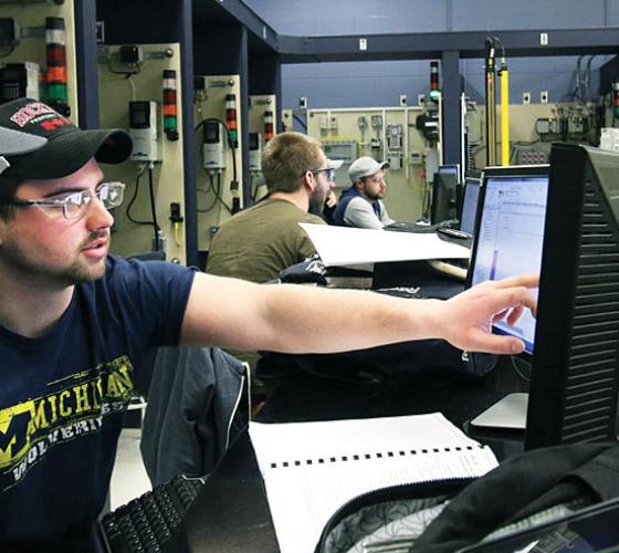 Male engineering students at computer stations.