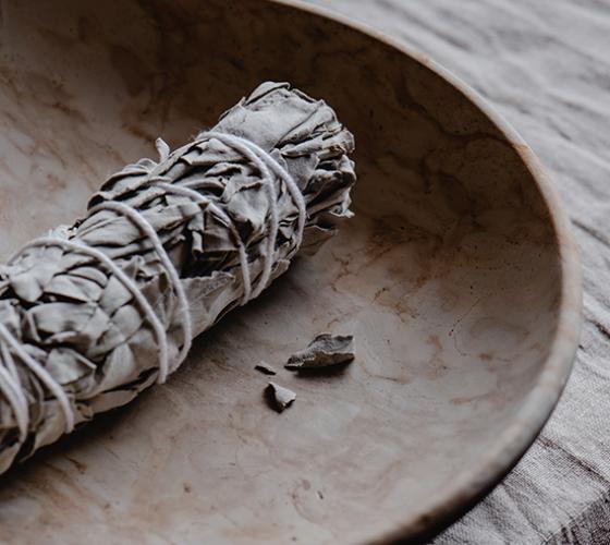 Smudge stick laying in a bowl prior to burning