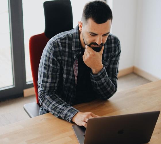 Man sitting at desk on a laptop