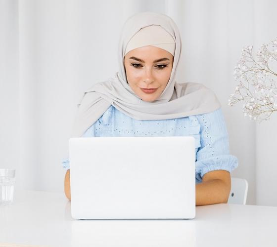 Woman at a desk working on a laptop