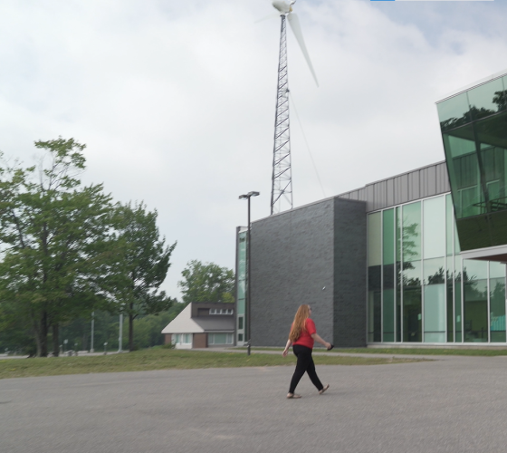 woman in red shirt walking up to F-Wing entrance