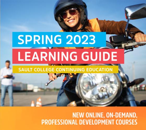 person on a motorcycle wearing sunglasses and smiling with blue sky and a person in background with text overlay spring 2023 learning guide