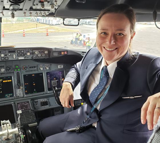 Stacey a graduate of Aviation Technology - Flight shown in a cockpit of a plane