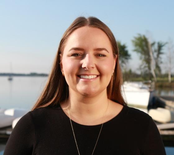 Sienna a graduate of our Bachelor of Science in Nursing program smiling with waterfront in background