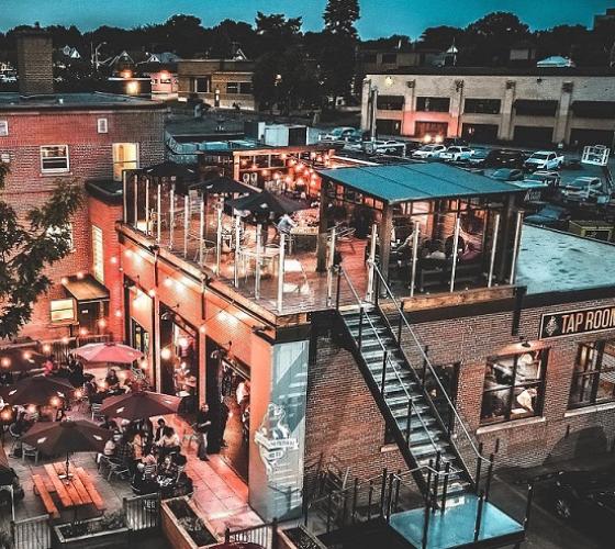 Outdoor view at night with patios at Tap Room from Northern Superior Brewery