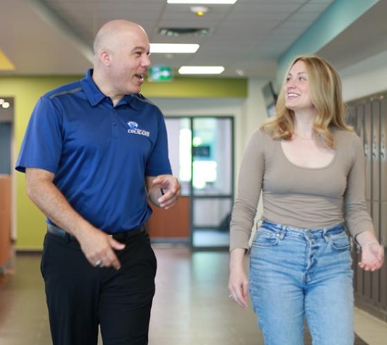 Recruiter chatting with prospective student while giving a tour of campus