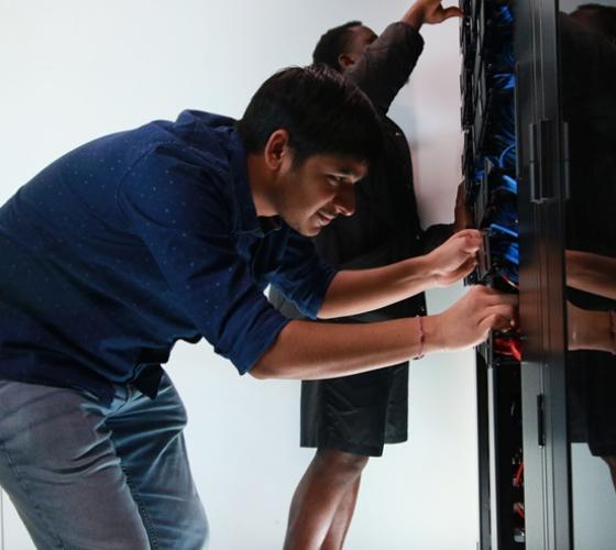 IT student Nitesh working in server room