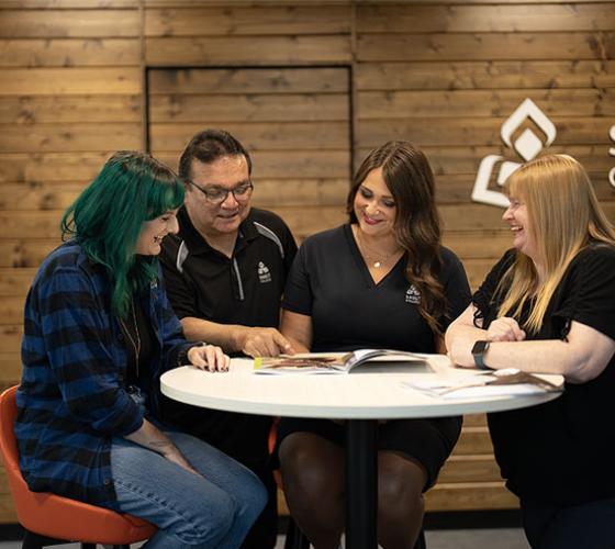 Four recruiters around a table in the welcome centre