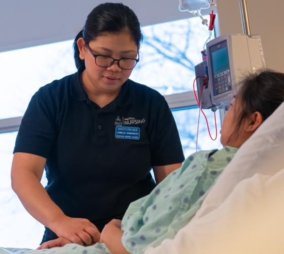 Practical Nursing student checking on patient