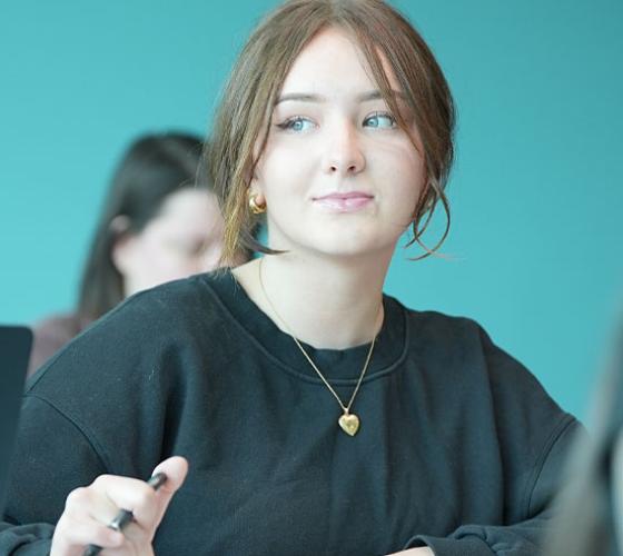 Student sitting in classroom looking to the side
