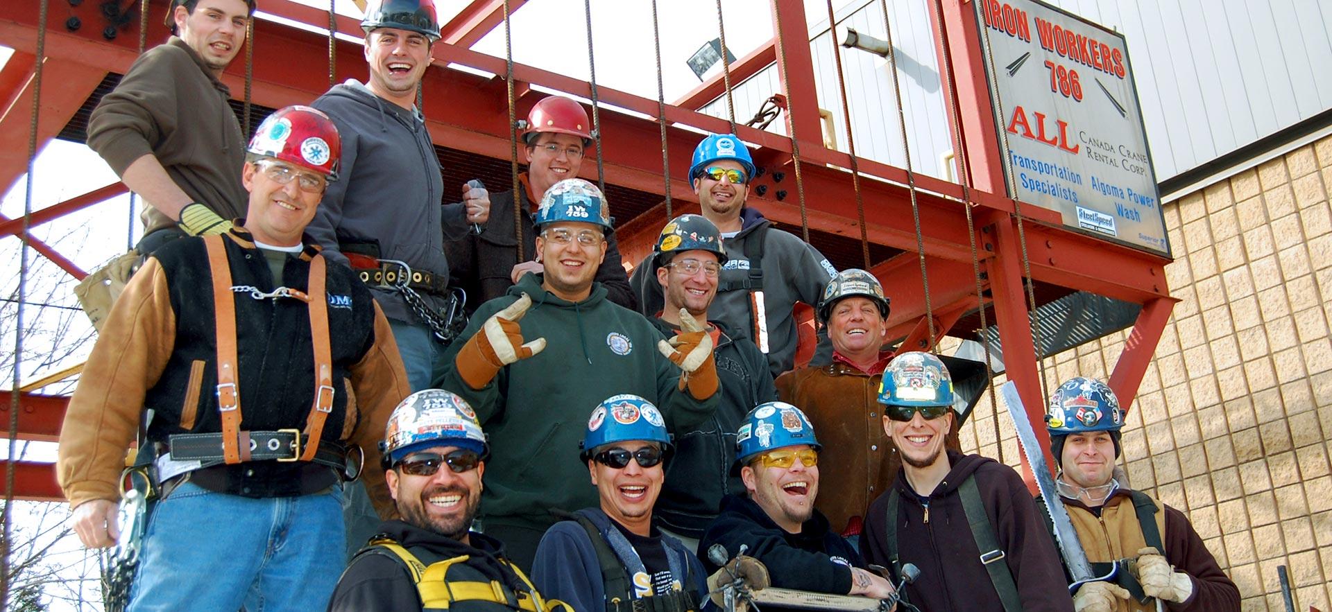 A group of smiling male Ironworker students pose for a class photo.                                                                    
