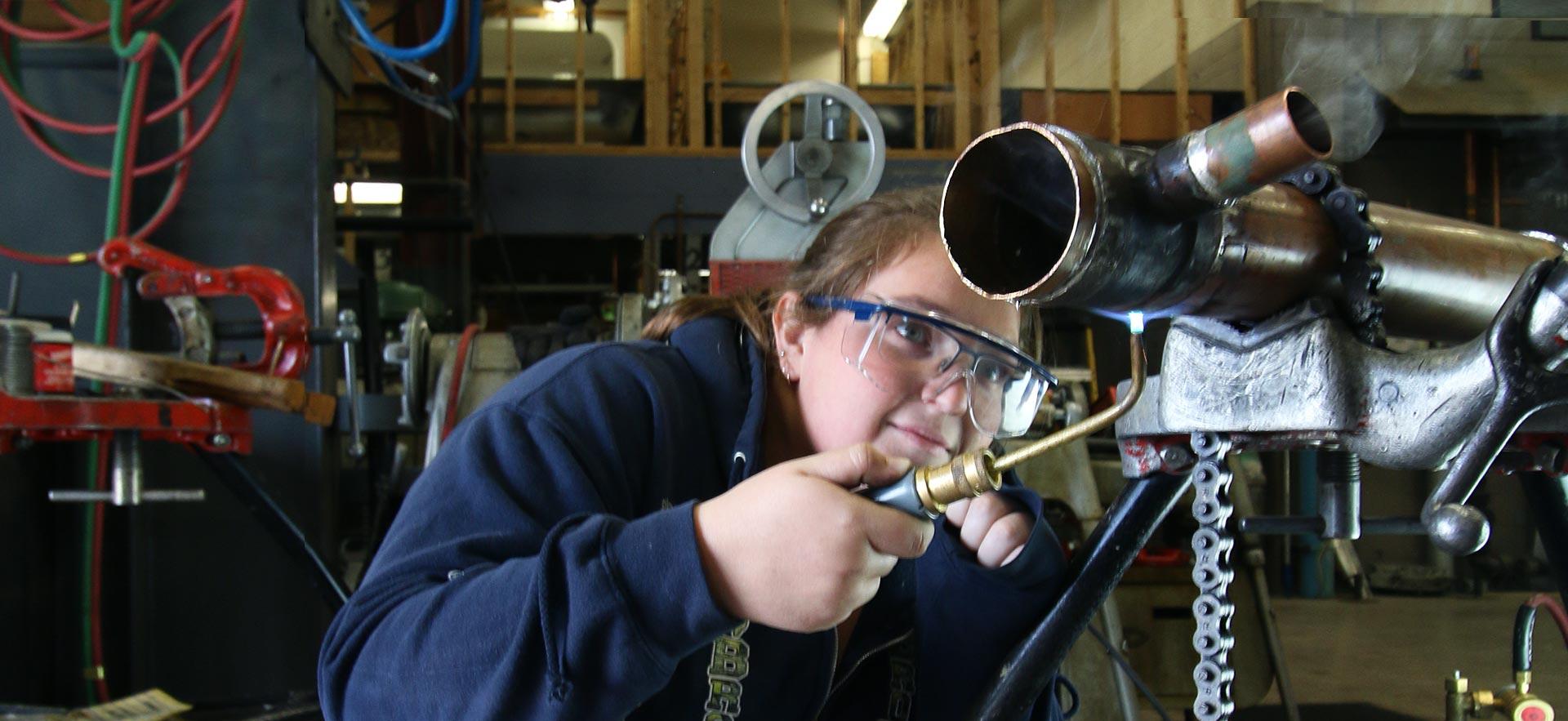 One female Steamfitting student works on a class assignment. 