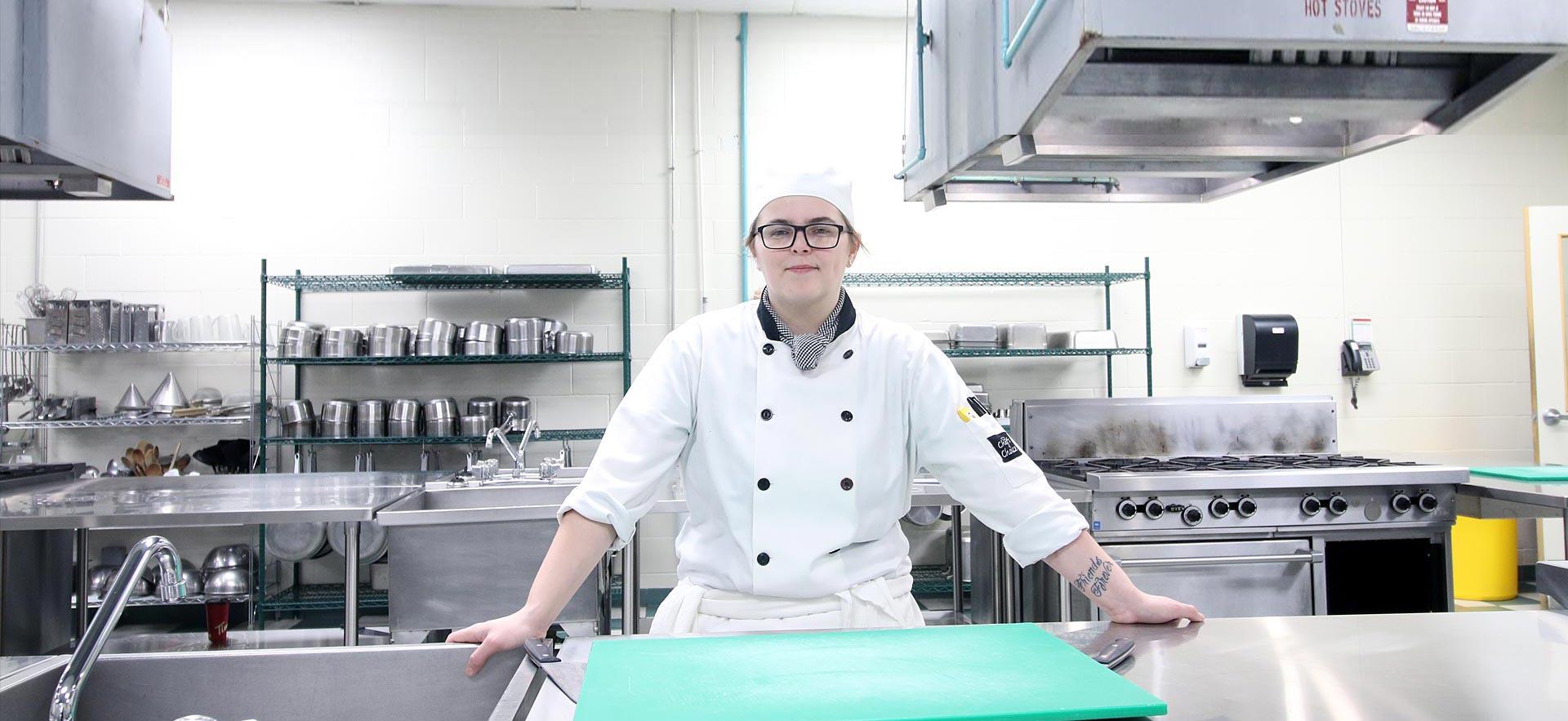 Female cooking student in one of the Sault College kitchens.