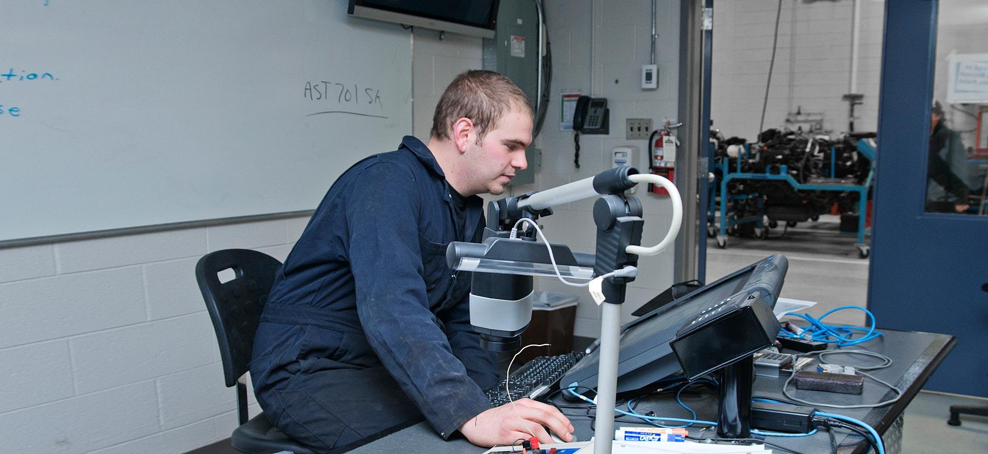 One male Parts Technician student works on a class assignment. 