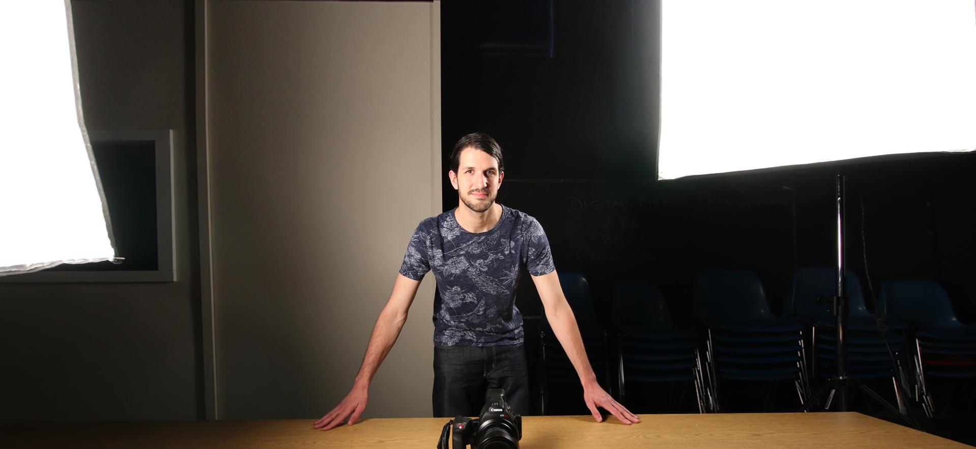 A Community Integration Through Cooperative Education student poses in the digital video studio.