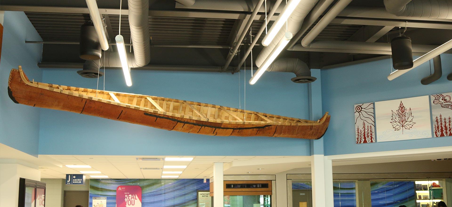 Sault College entrance that displays indigenous items. 