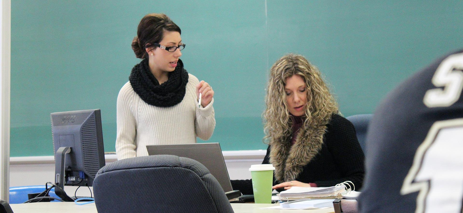 Female Academic Upgrading Literacy and Basic Skills instructor prepares for class. 