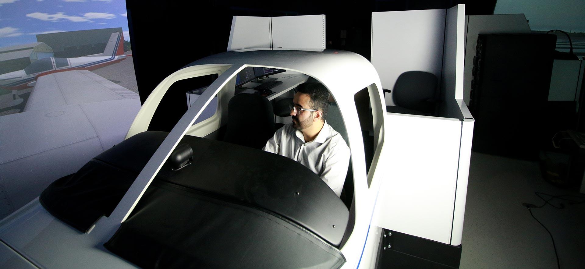 Aviation instructor operating one of the flight simulators.