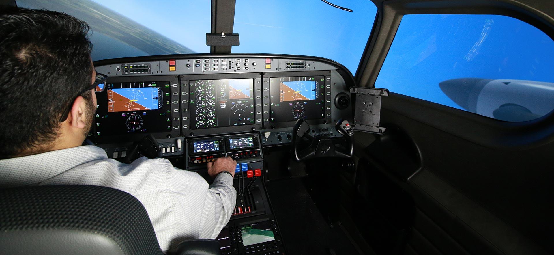 Aviation instructor operating one of the flight simulators.