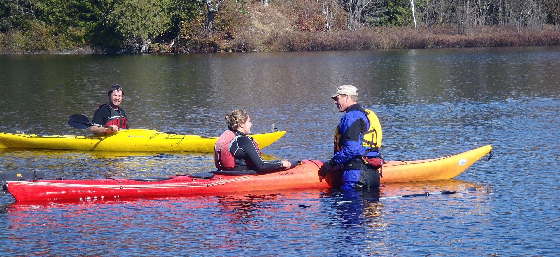 Male Adventure Recreation instructor teaches safety on a kayak.