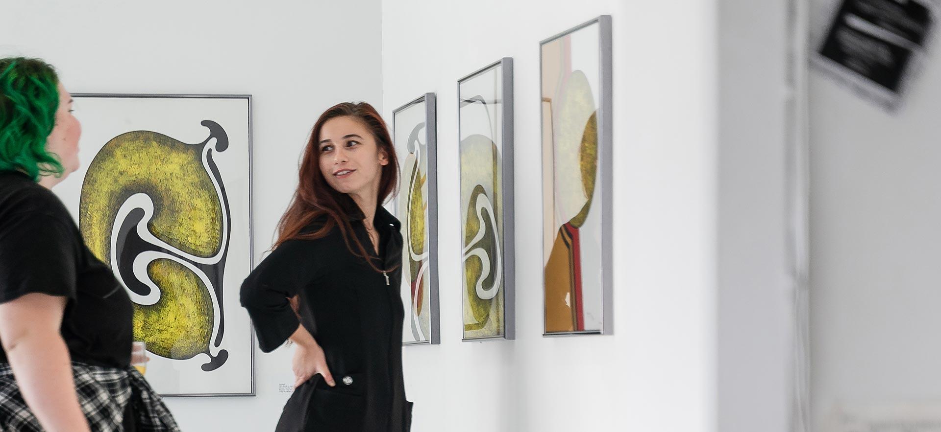 Two young women in an art gallery.
