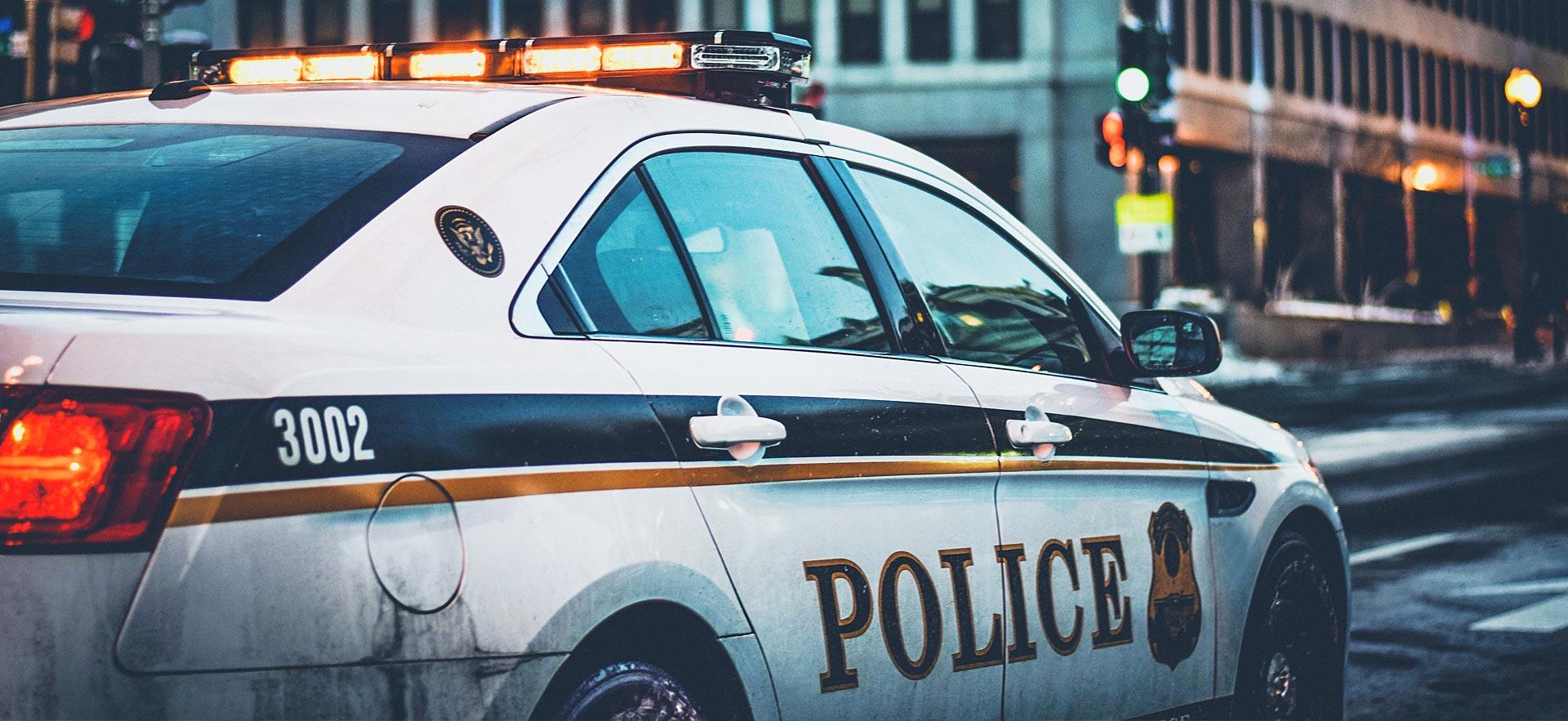 Image of a police car on a city street.