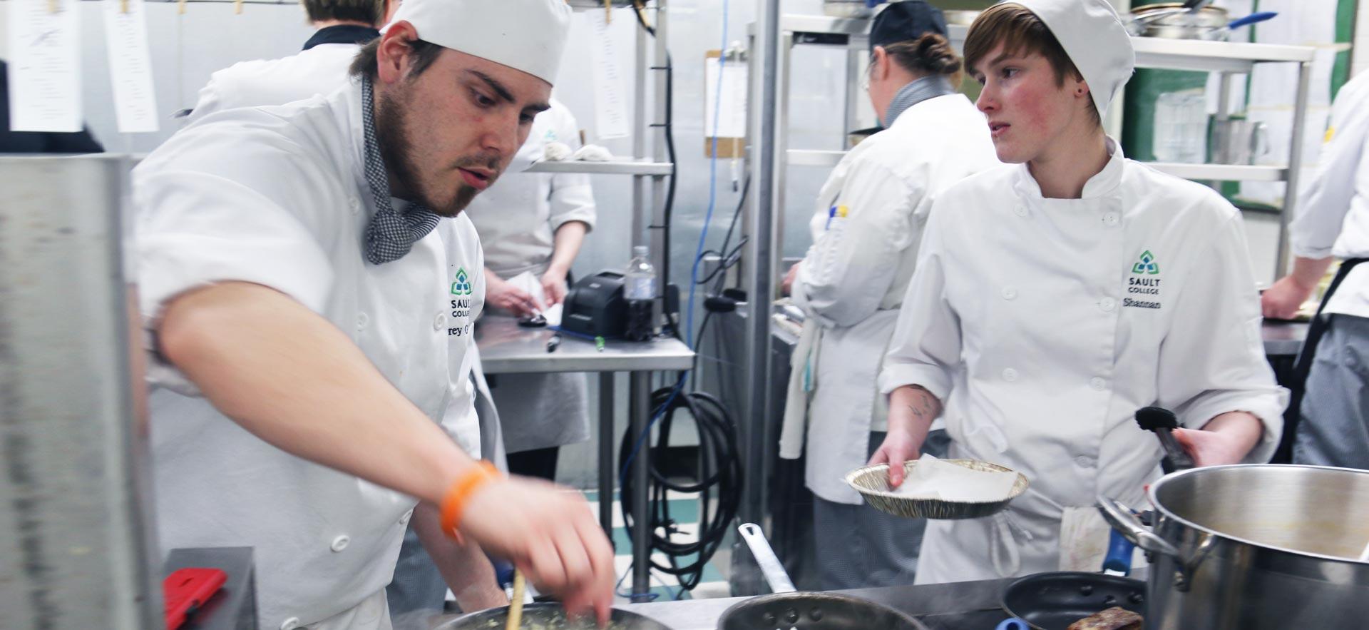 Busy culinary students work on an assignment in one of the Sault College culinary kitchens.